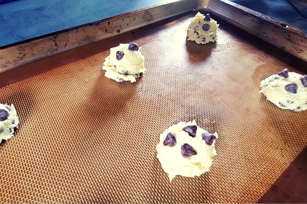Chocolate chip cookie dough sitting on a baking sheet. These are soft and chewy cookies and so delicious! You'll love making this classic chocolate chip cookie recipe without brown sugar.