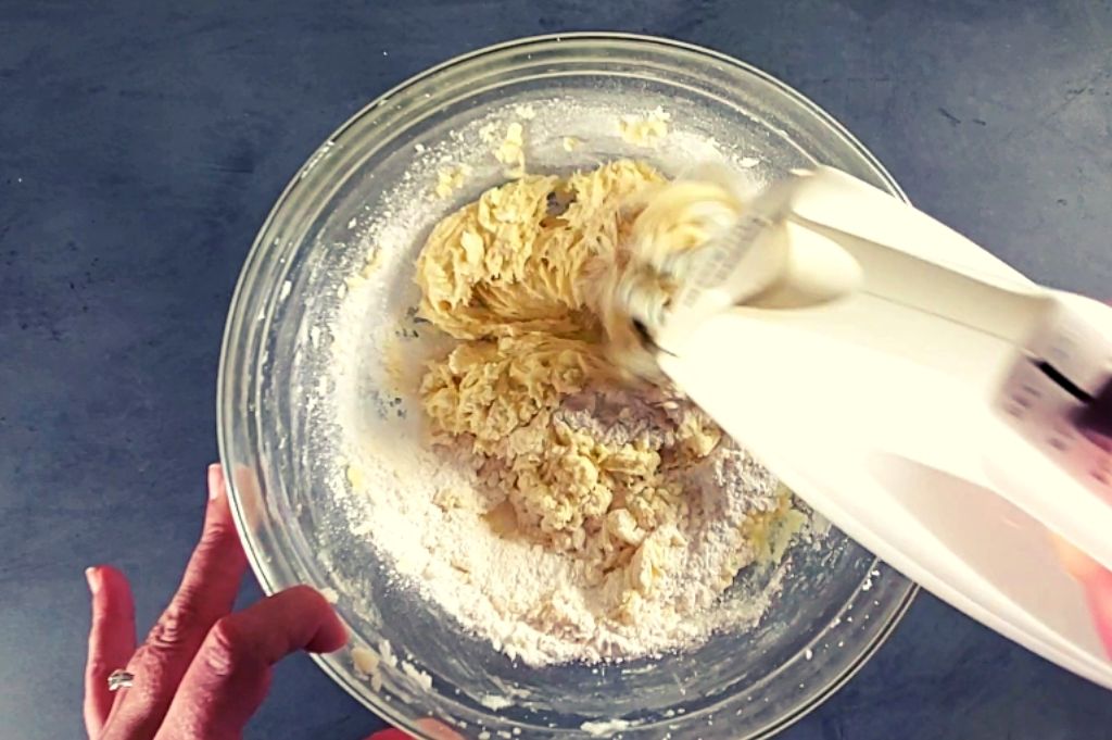 An electric mixer is mixing the dry ingredients into the wet ingredients to make this traditional chocolate chip cookie recipe without brown sugar. You will love these soft chocolate chip cookies.