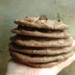 Chocolate chip brownie cookies stacked on hand